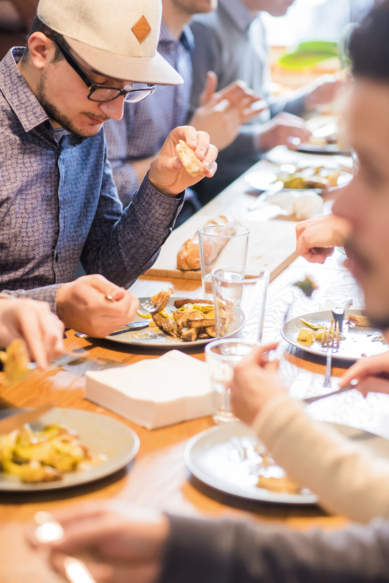 Colleagues eating lunch together at an office table