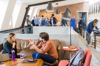 IT consultant discussing strategy with clients in a modern office setting