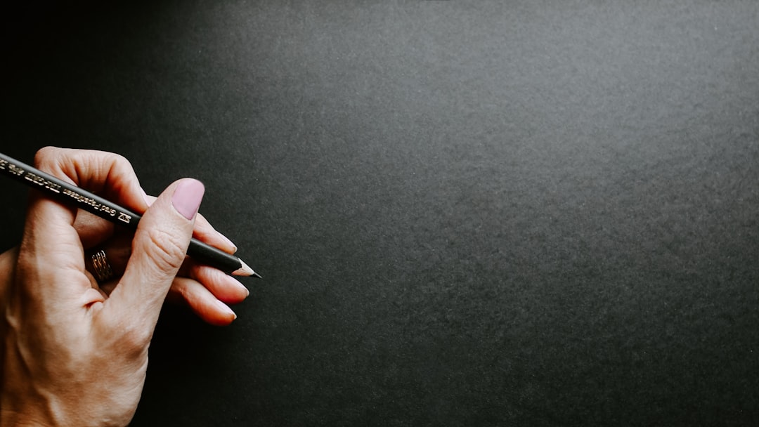 person holding black pencil