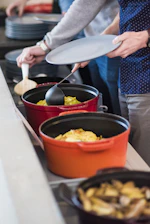two red and orange cast-iron cooking pots