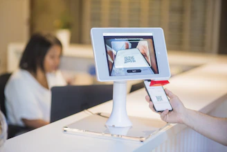 Technician scanning a barcode on a spare part using a tablet.
