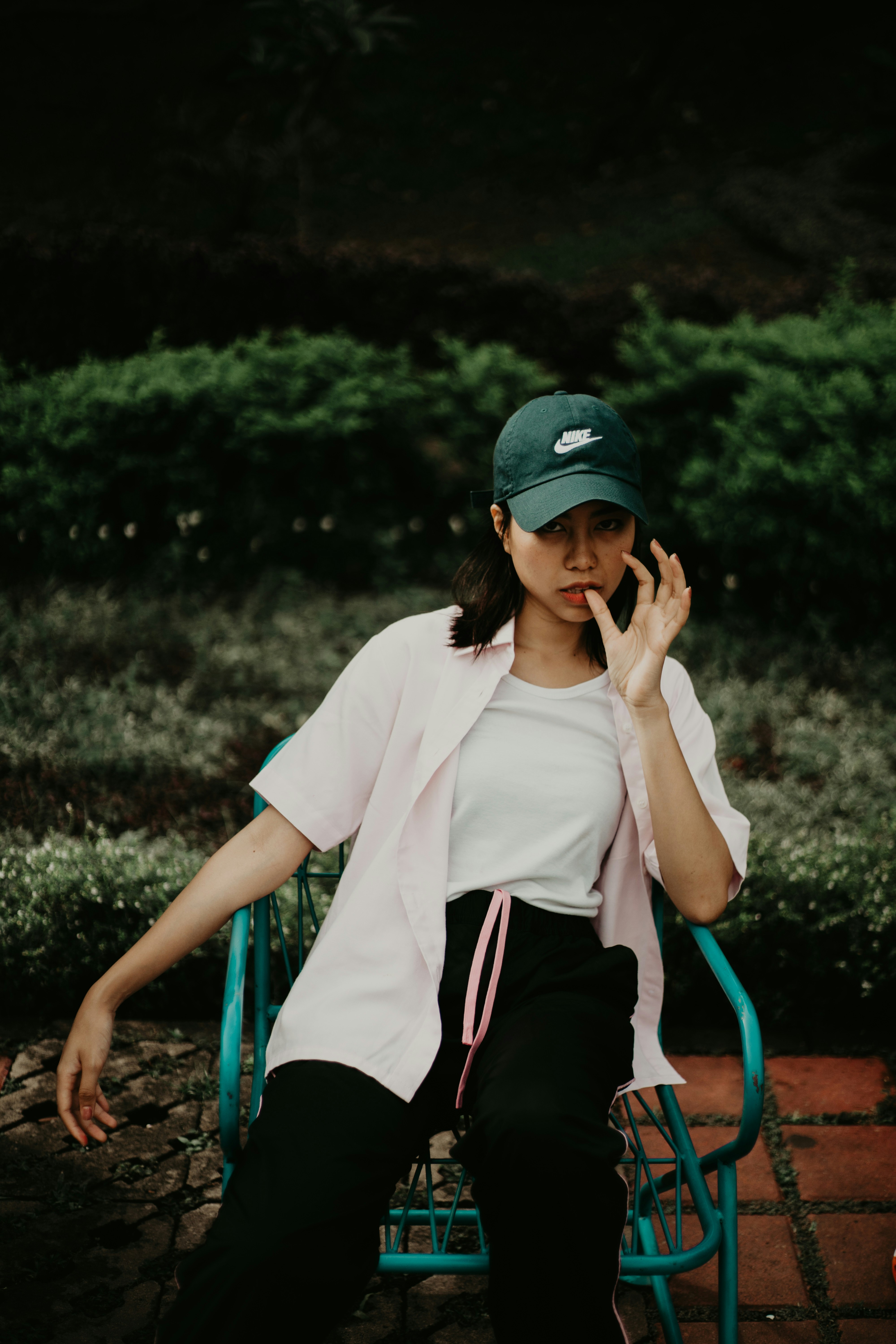 sitting woman wearing white dress shirt and black cap