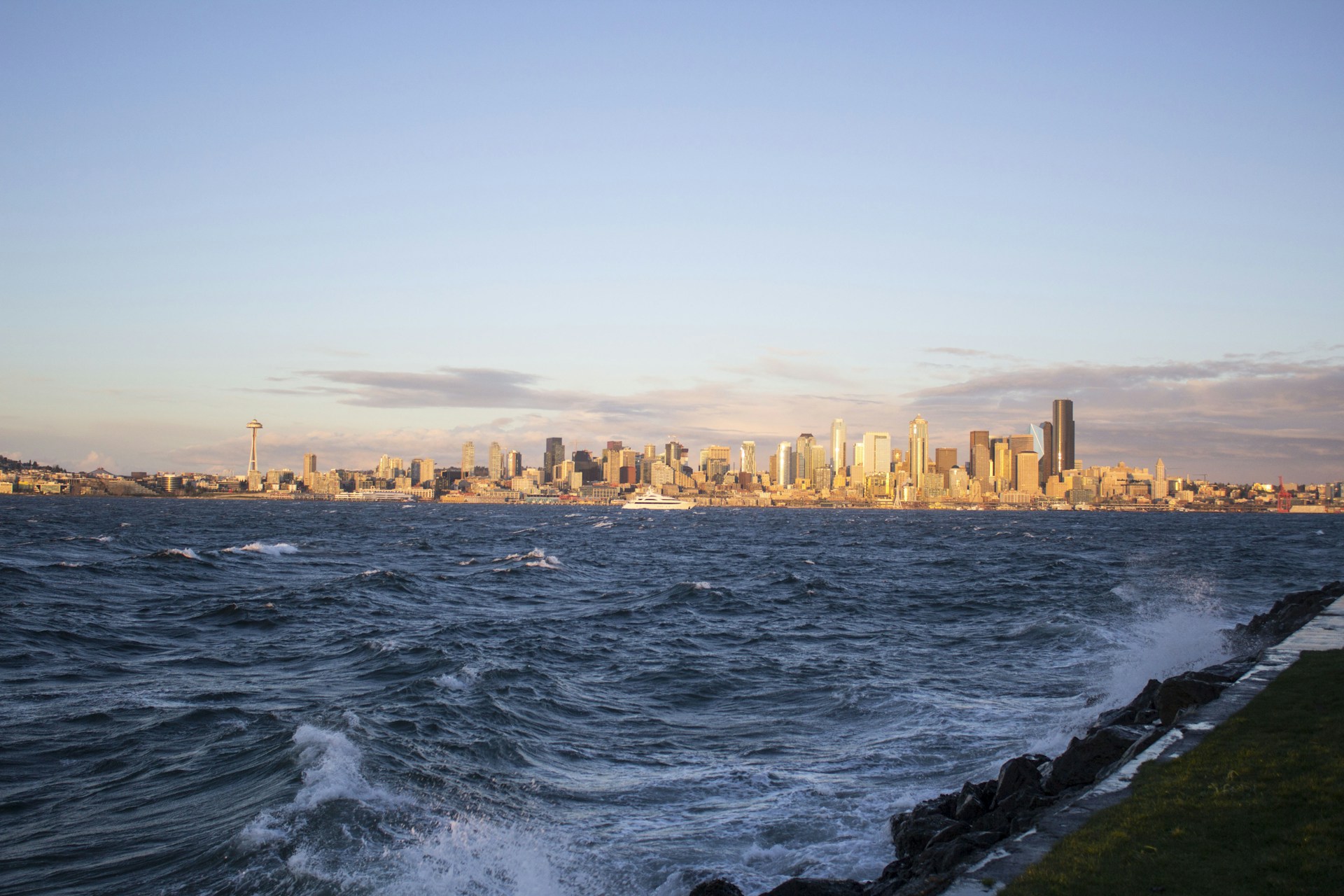 A dynamic aerial shot capturing Lagos's sprawling cityscape at golden hour, with vibrant yellow hues reflecting off the water.