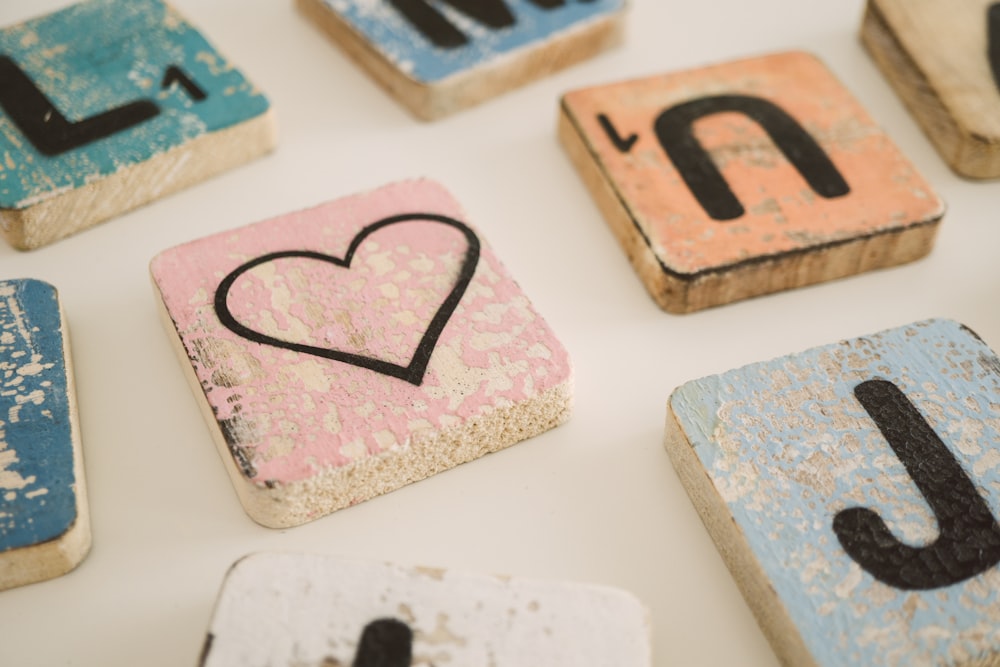 scrabble blocks and heart block on white surface
