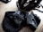 A close-up of a helmet, lock, and bag arranged neatly on an e-bike.