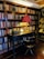 A cozy writing nook with a vintage typewriter and a stack of books on a wooden desk.
