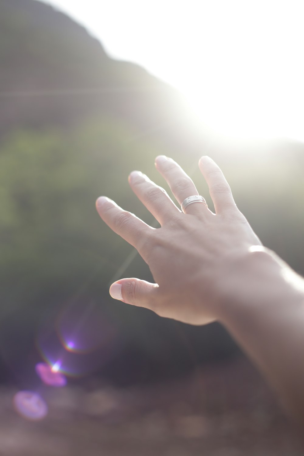 person wearing silver-colored wedding band