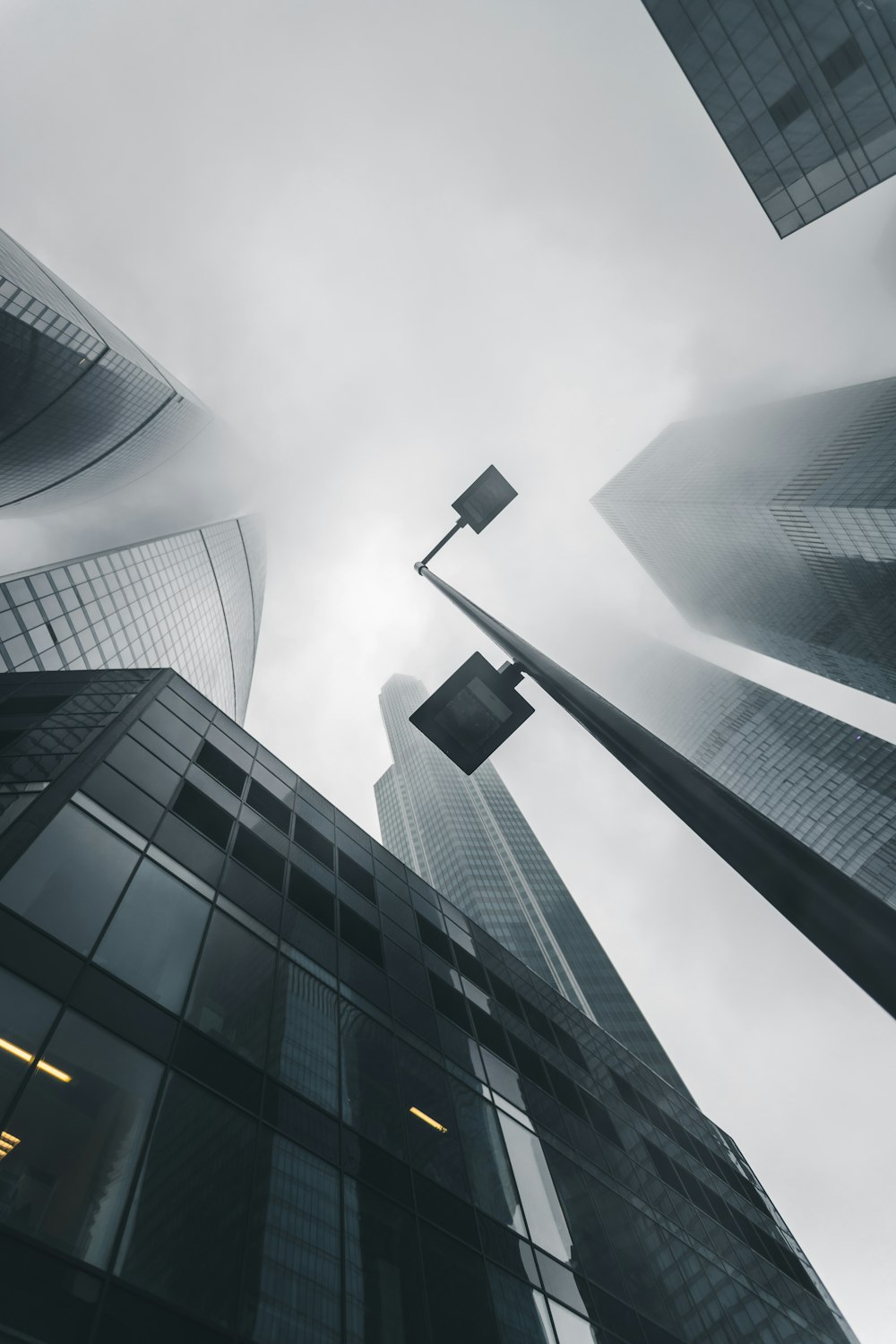 low angle photography of black-and-gray buildings