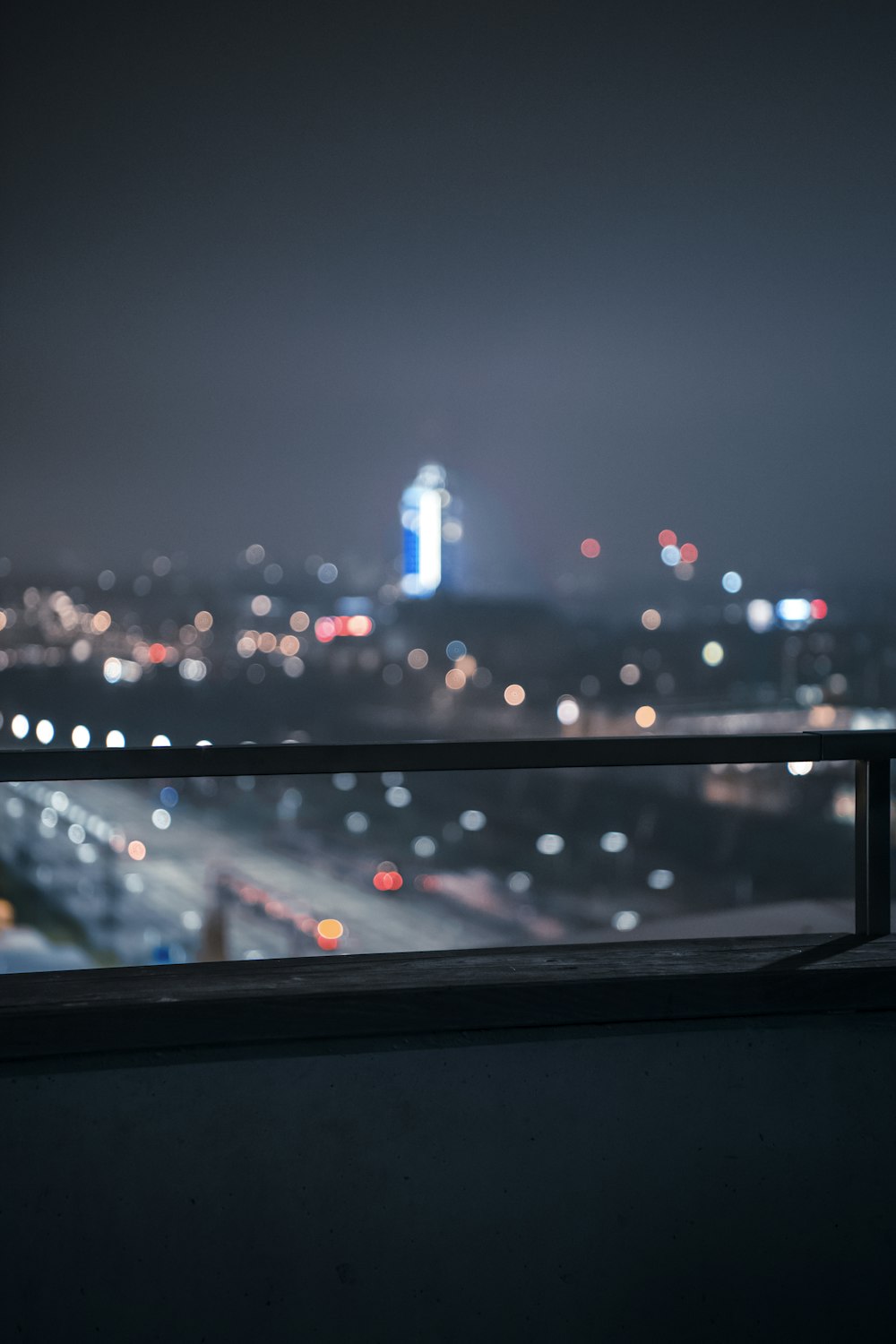 a view of a city at night from a balcony