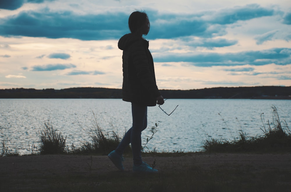 woman next to body of water