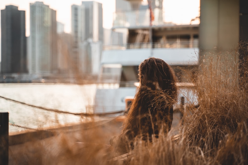 woman sitting in front of city scape