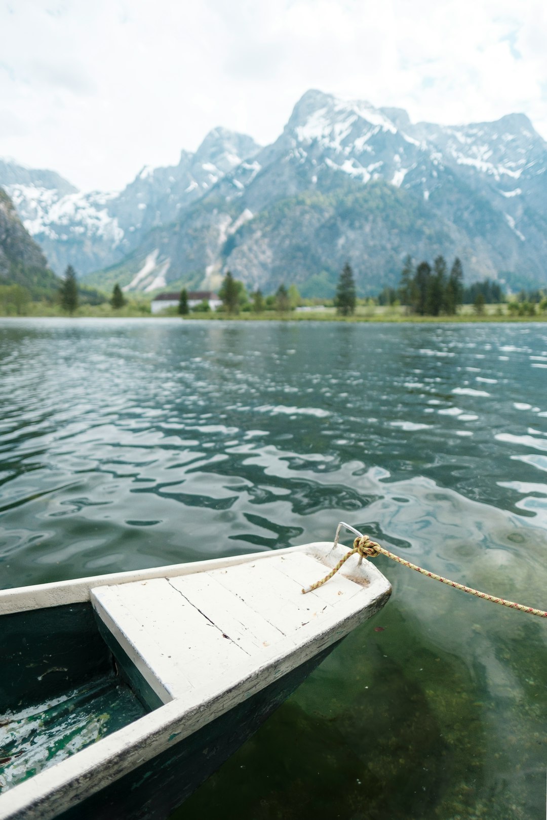 white wooden boat on body of water