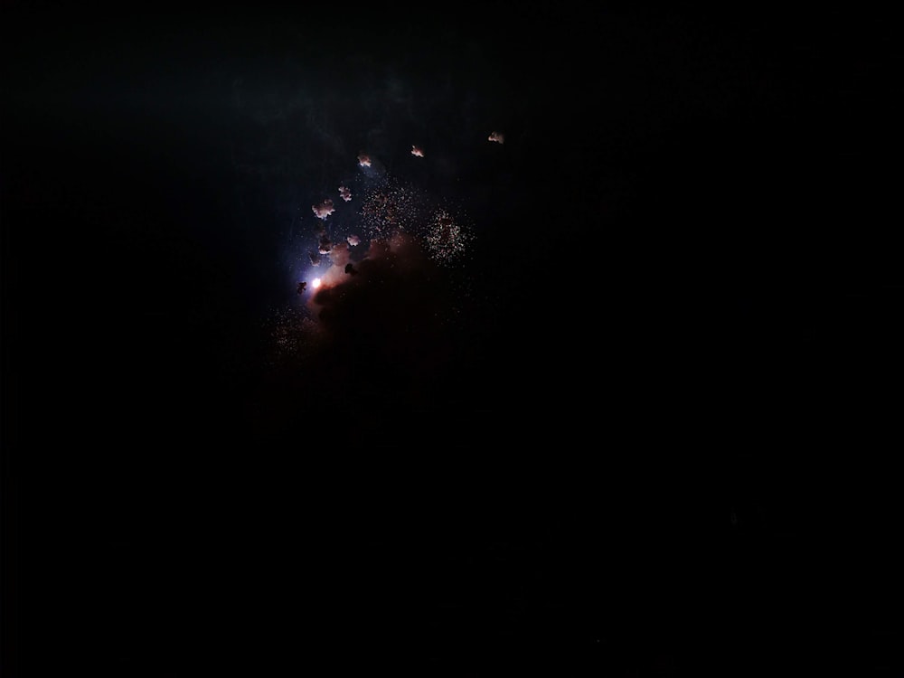 fireworks are lit up in the dark sky