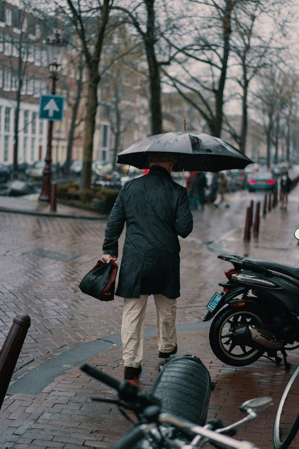 man holding black umbrella
