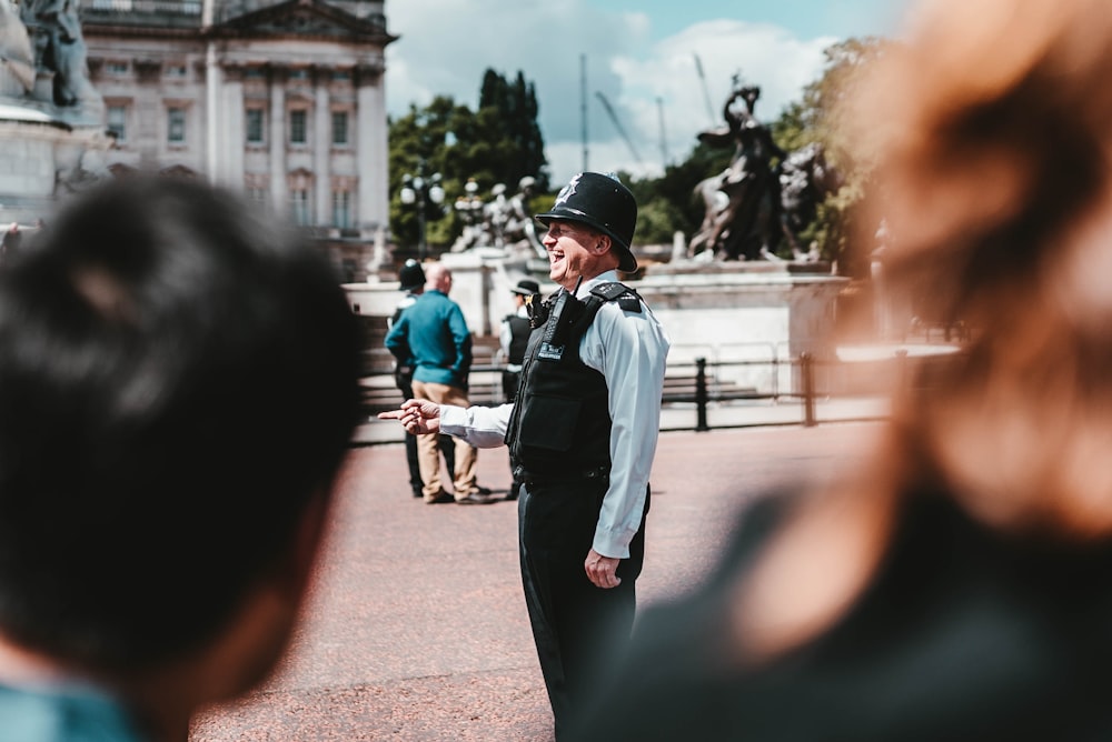 man in police uniform standing in open area