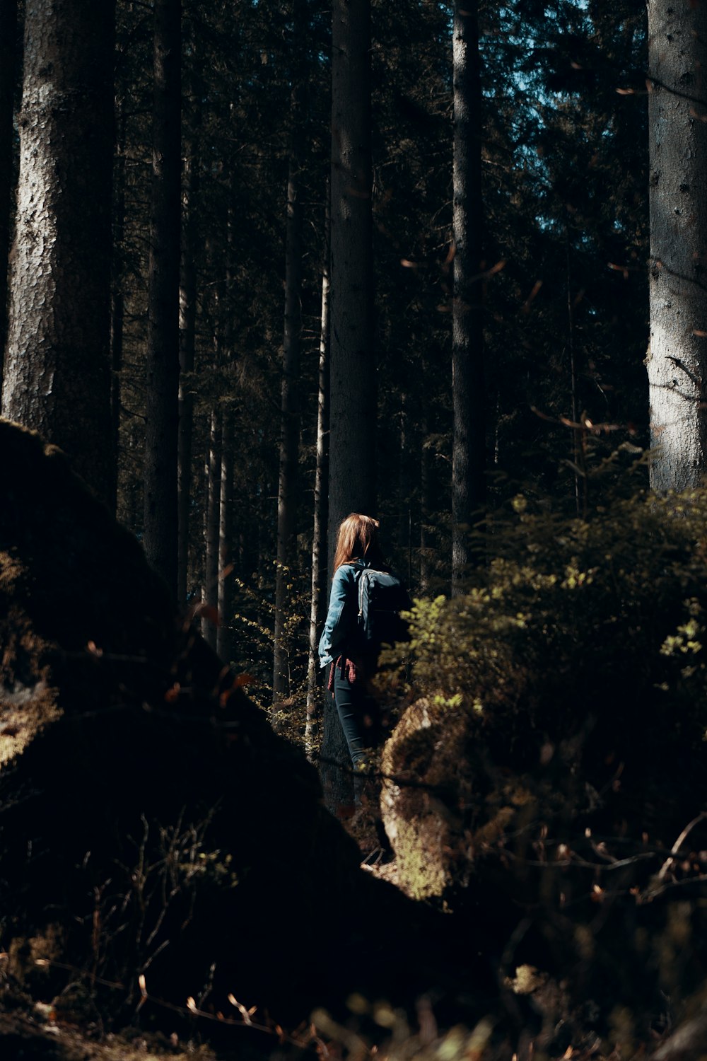 woman standing on forest