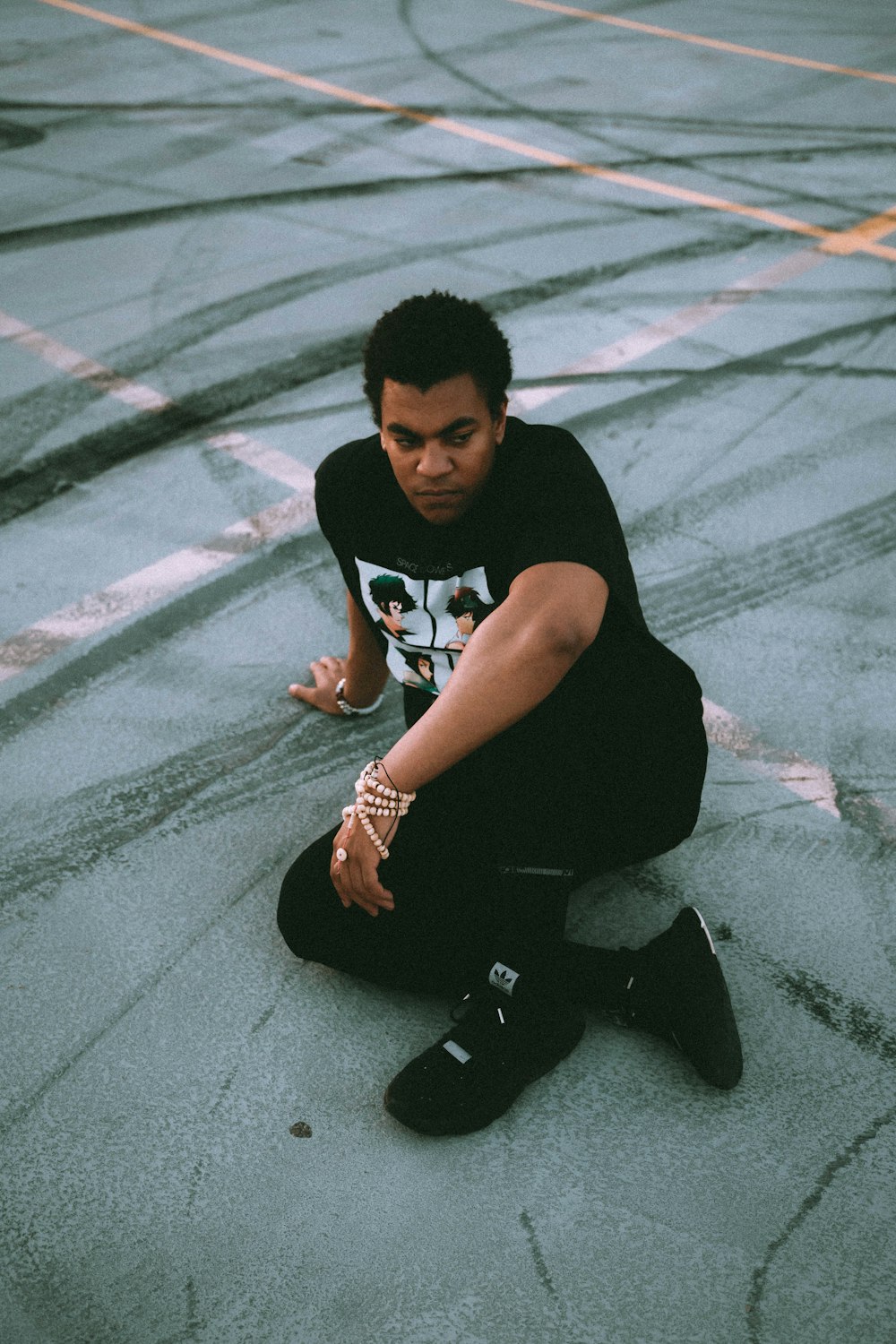 man sitting on concrete surface