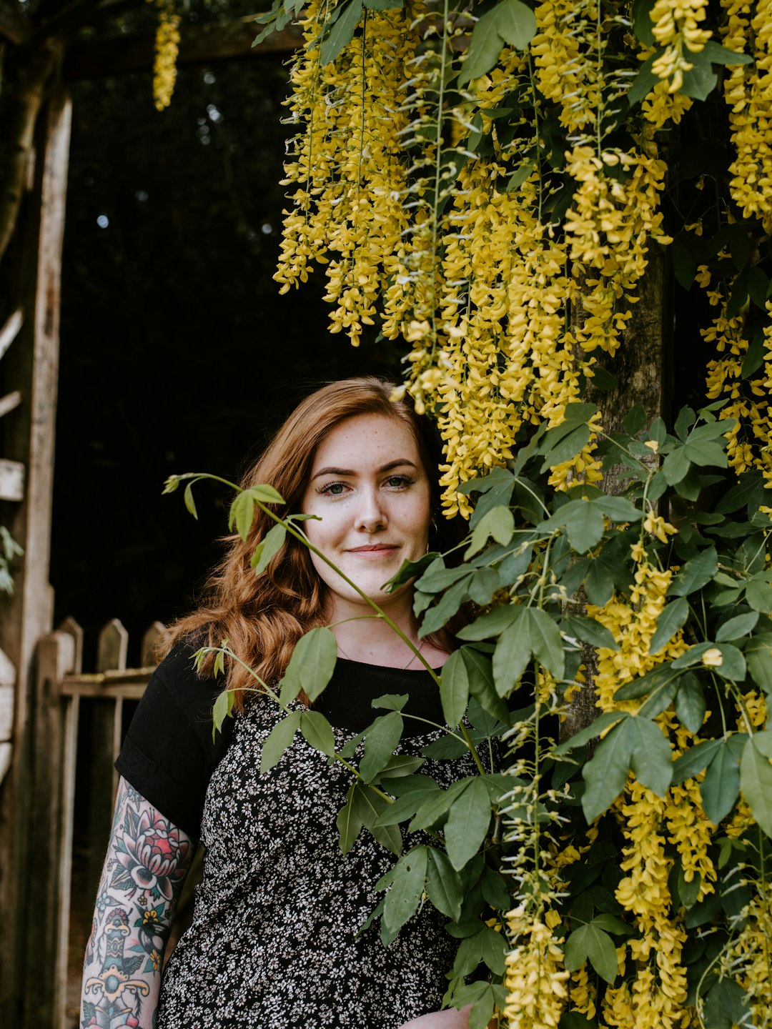 woman standing near yellow flowers