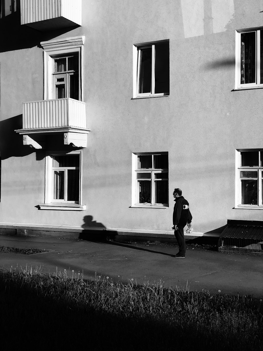 man standing near building