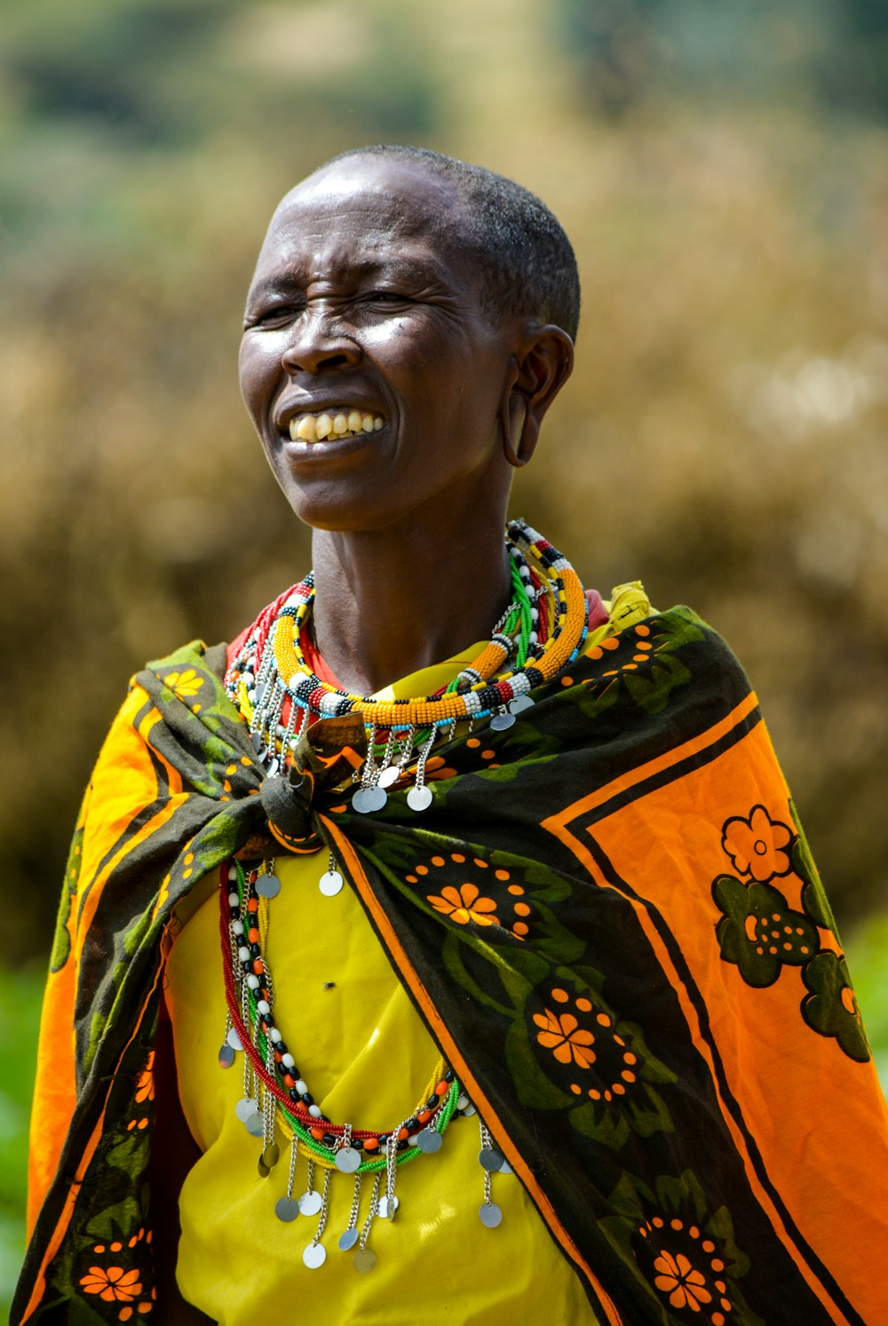 man in yellow shirt with green and orange floral scarf