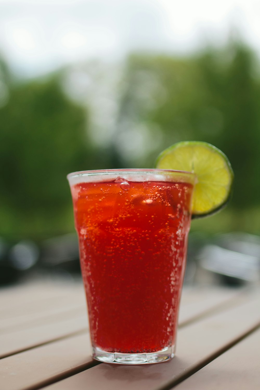 clear drinking glass fiild with red liquid