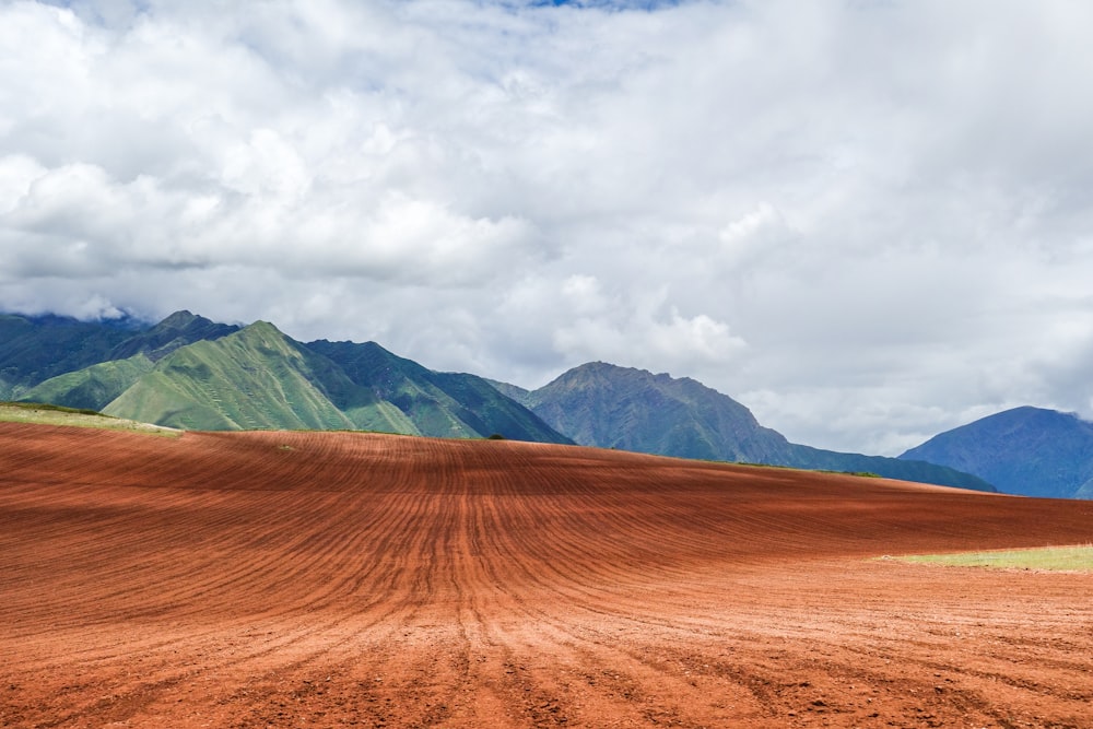 landscape photography of farm under white clouds