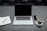 A serene workspace with a laptop, a cup of tea, and a notepad.