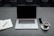 A close-up of a modern workspace with a laptop, notepad, and coffee cup, symbolizing creativity and productivity.