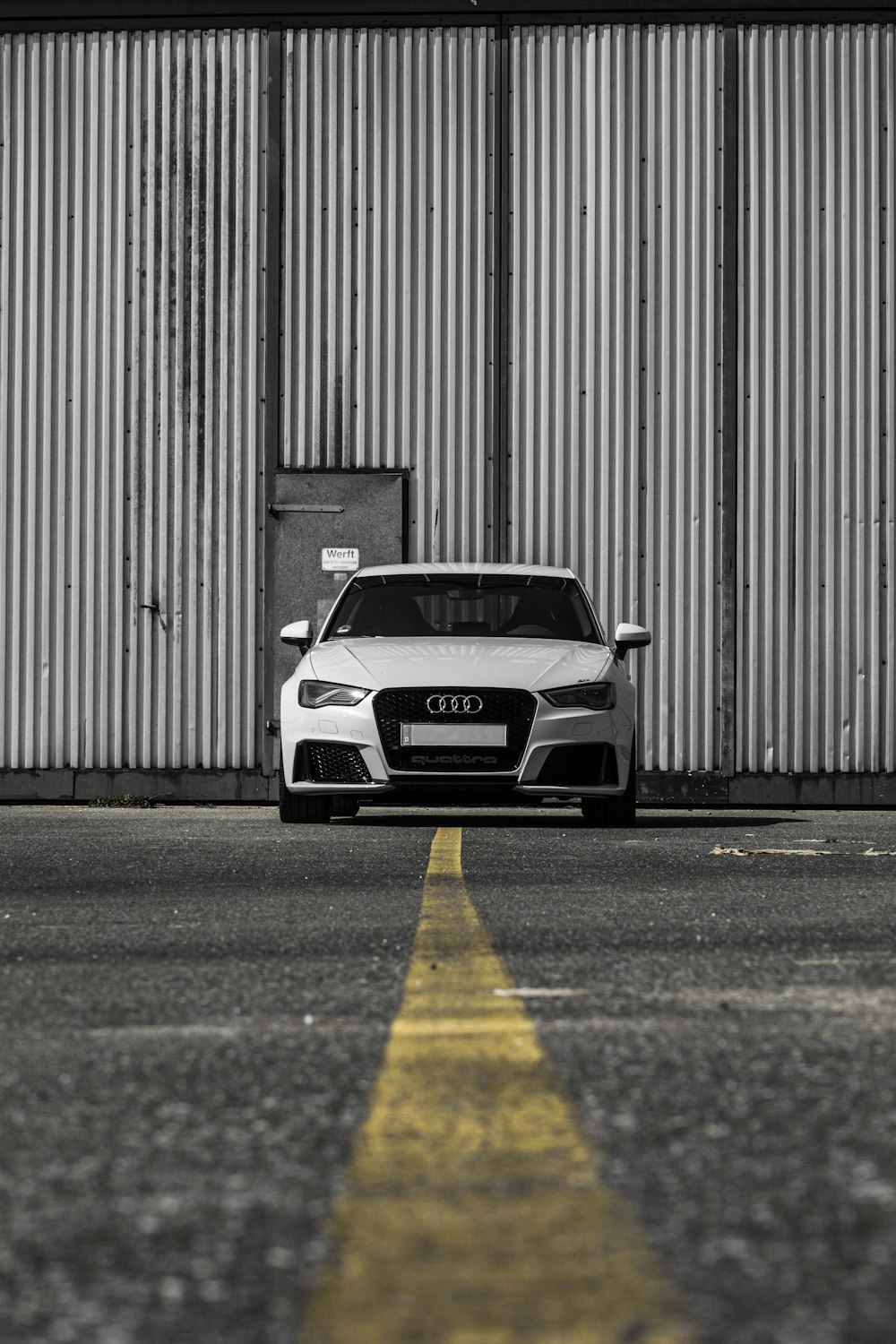 white Audi vehicle on road