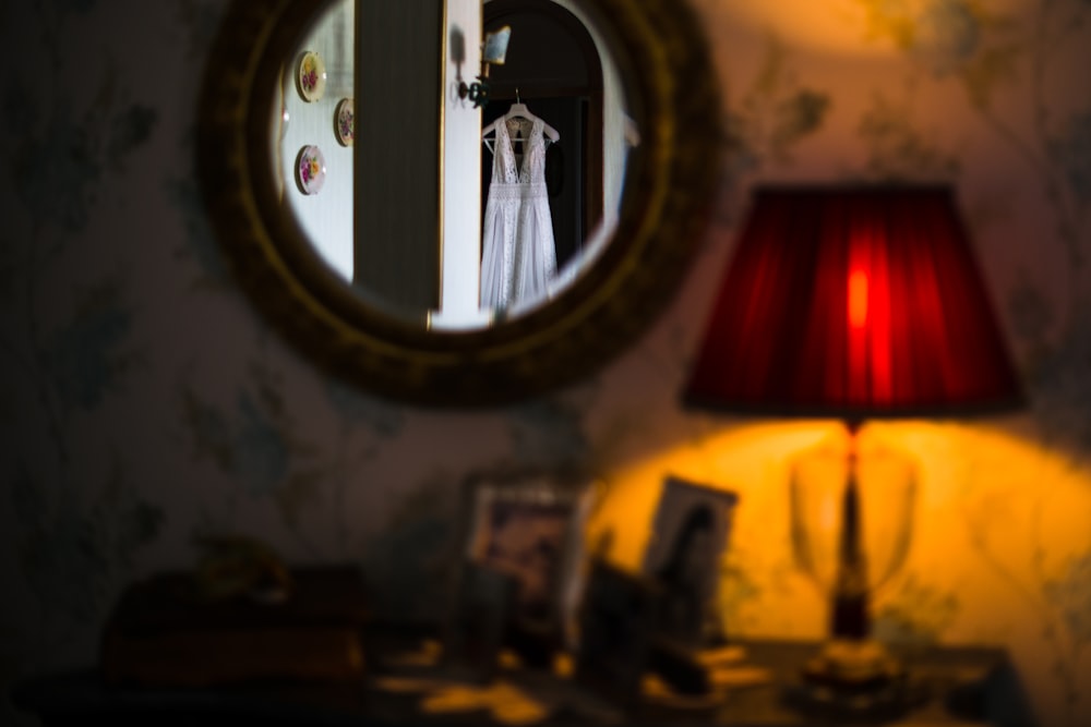 red table lamp near mirror