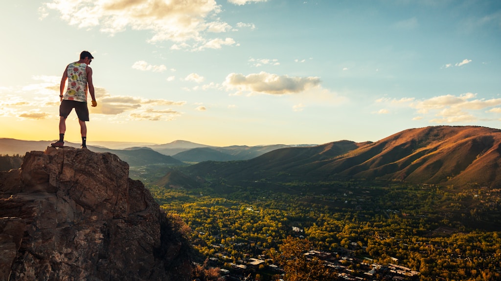 landscape photo of a man on a cliff