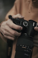 Close-up of hands adjusting camera settings during a live cultural event.