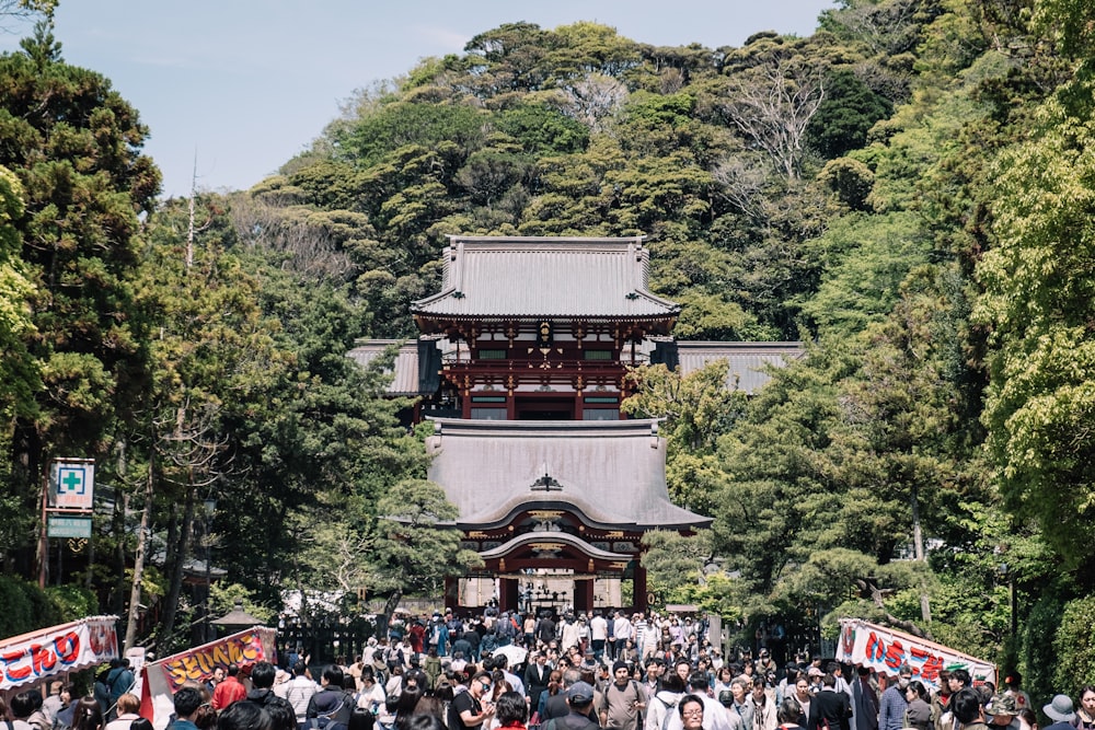 people outside temple surrounded by trees