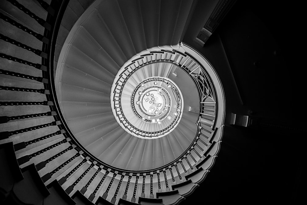 grayscale photo of spiral stairs