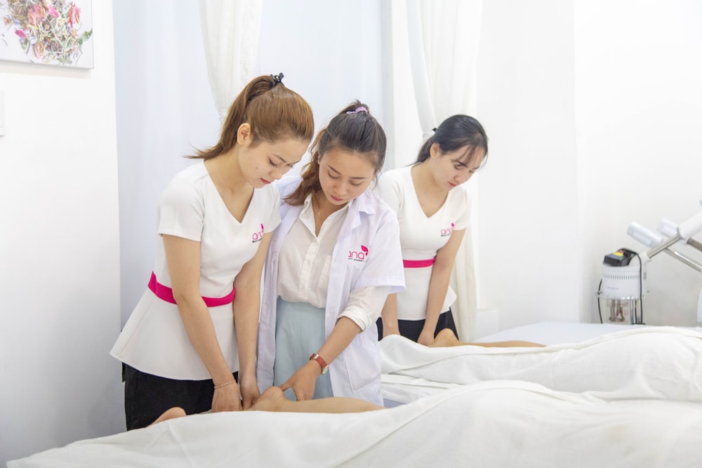 one woman assisting another woman in massaging