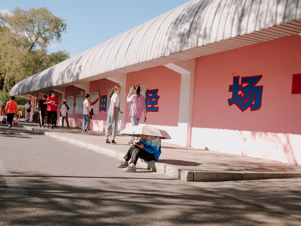 people near red concrete building during daytime