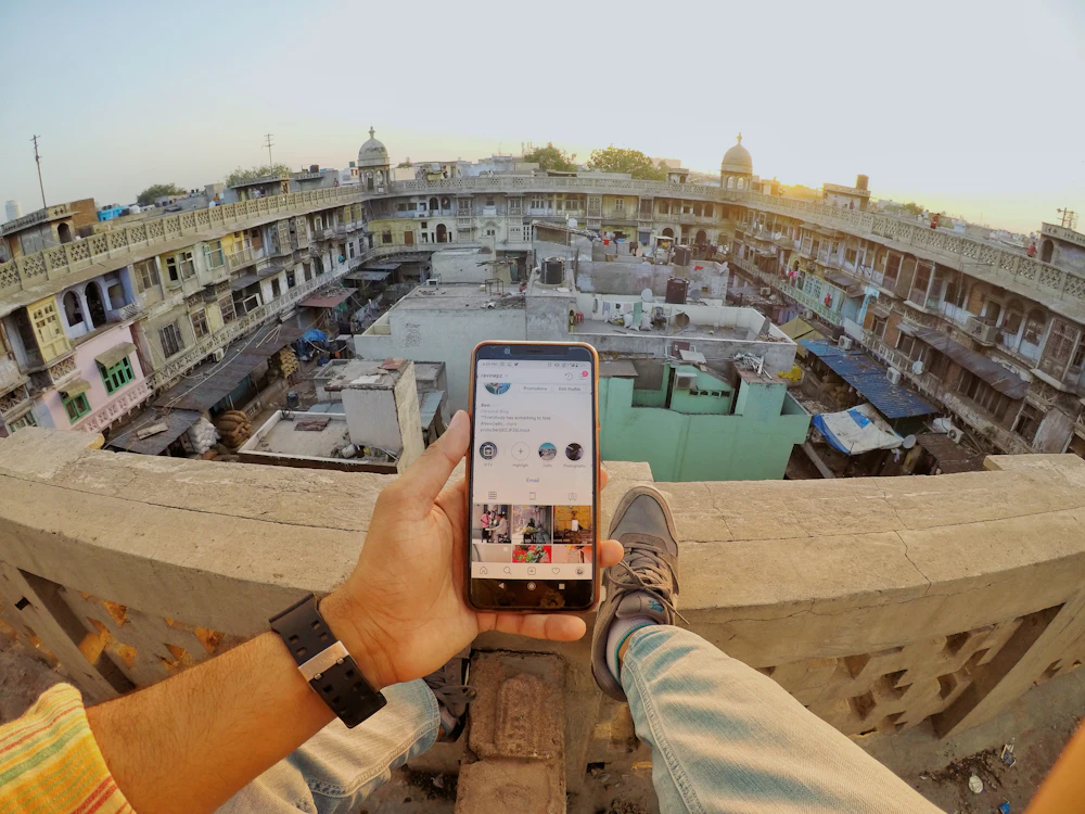 Person holding an Android smartphone above a city street