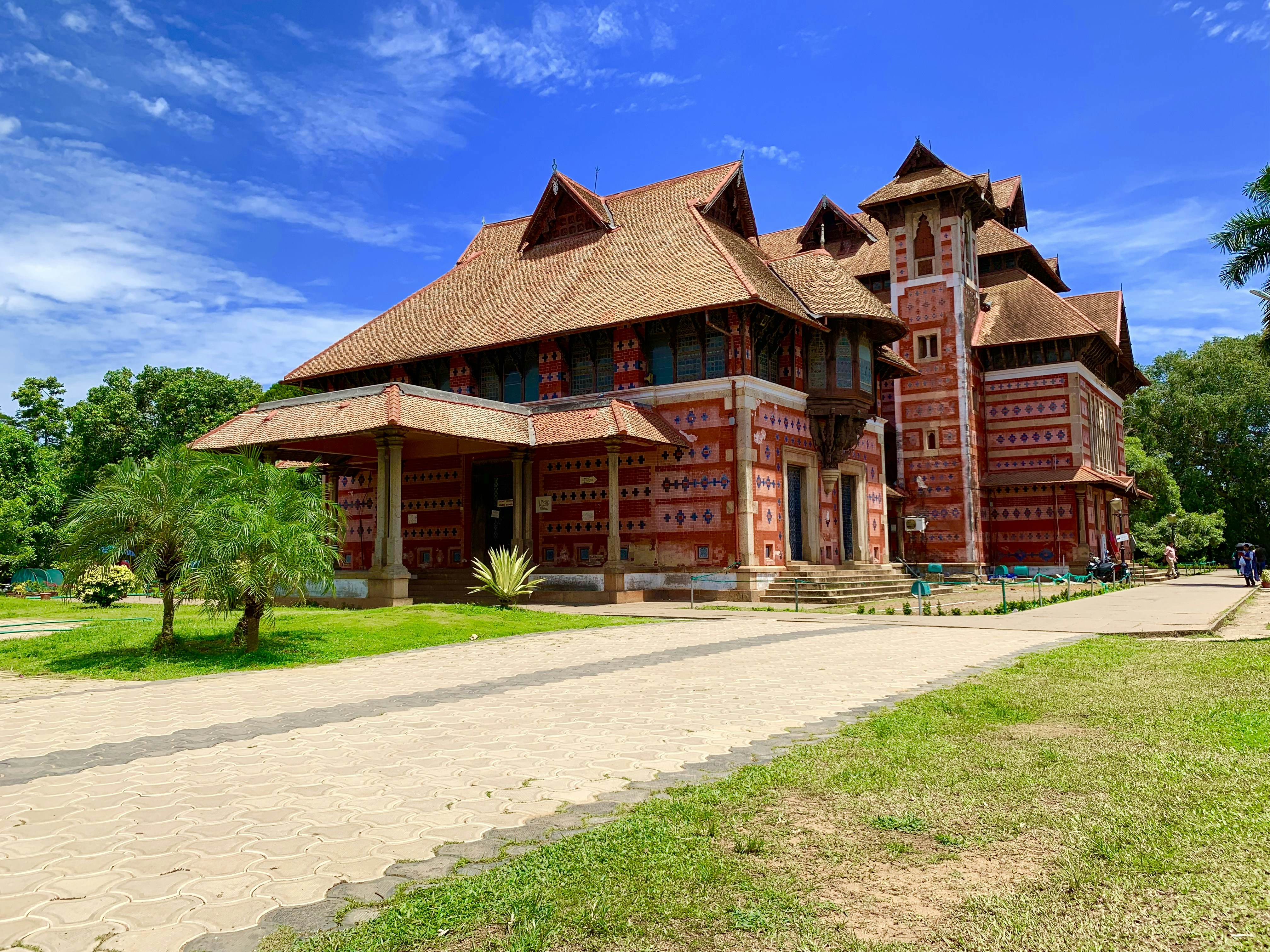 red concrete building surrounded by trees