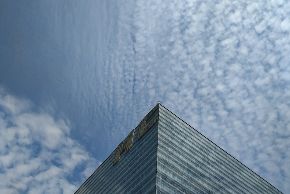 a very tall building under a cloudy blue sky