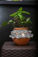 A vibrant ceramic planter holding a lush green plant, highlighting craftsmanship and nature.