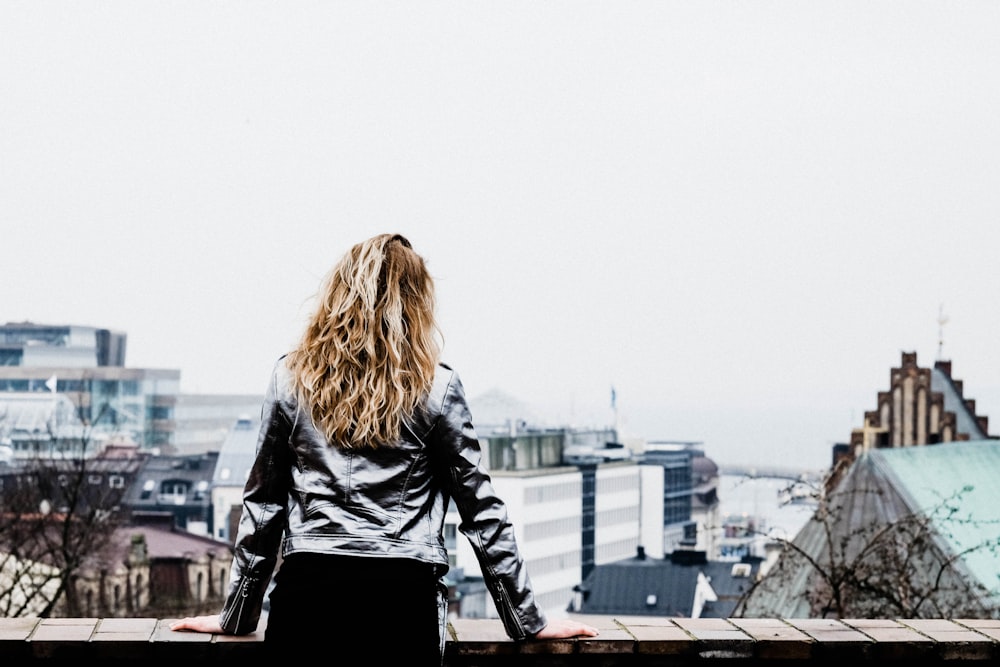 woman leaning on concrete firewall