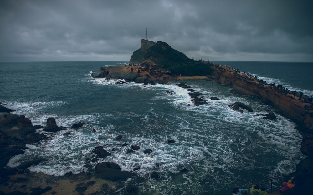 sea stack near sea during daytime