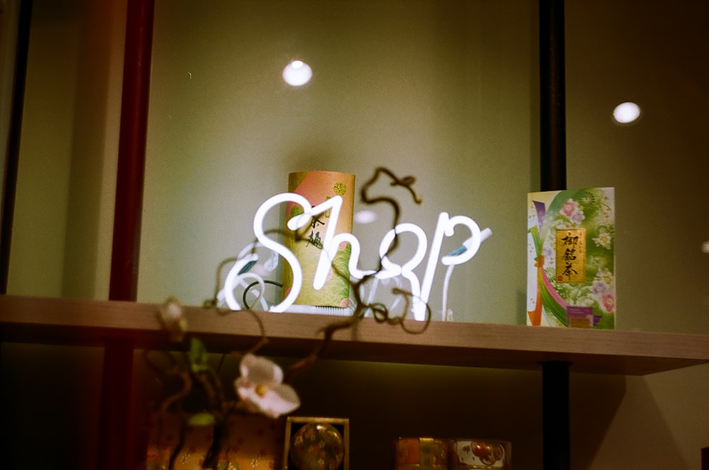 white shop led light on top of brown wooden wall rack