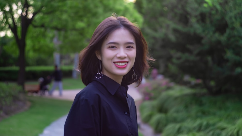 smiling woman wearing black collared blouse