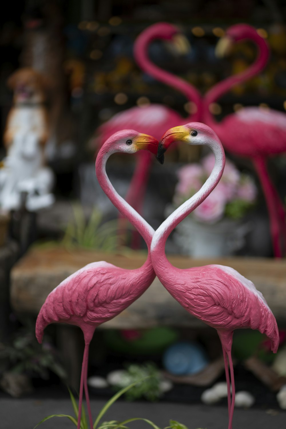 two pink flamingo ceramic figurines