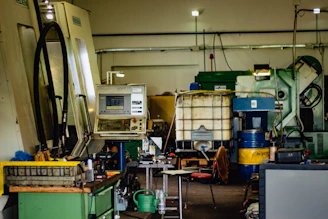 Industrial workshop with skilled workers operating CNC machines in a clean environment.