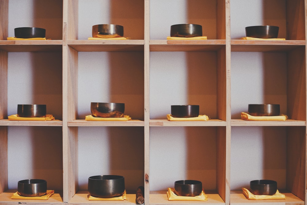 brown wooden cubby shelf with bowls