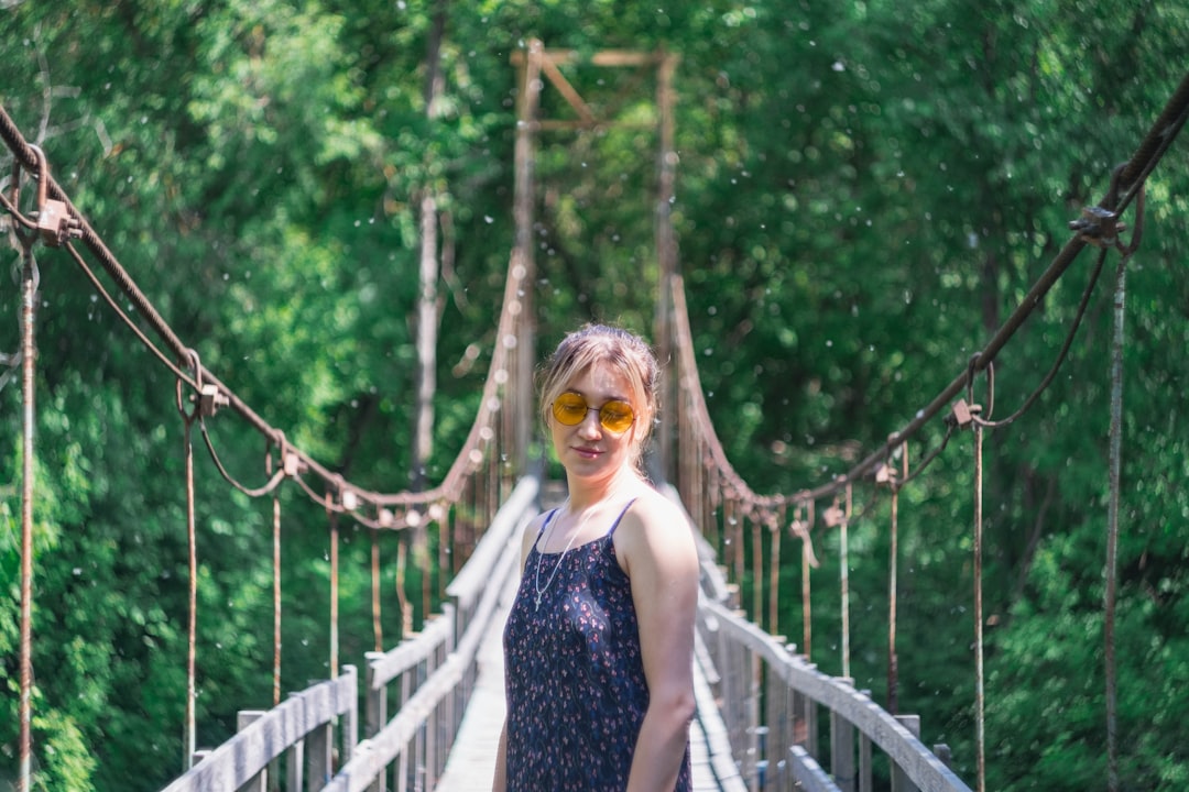 woman standing on hanging bridge