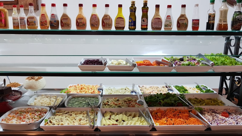 Buffet food display with various dishes arranged in warming trays at a hotel restaurant