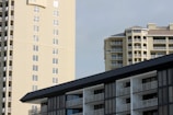 Modern residential buildings with balconies under a clear sky.
